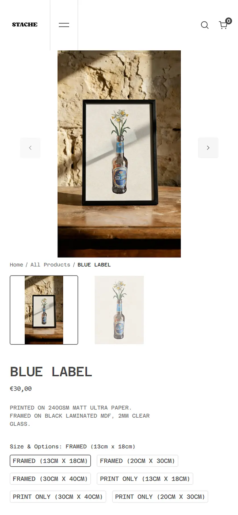 The Blue Label product page on mobile. The framed print is photographed on a rustic wooden table against an exposed limestone wall. Below the hero photo, a thumbnail gallery, the product title and price 30 euros, a paper and frame spec line, and a Size and Options variant picker with six choices spanning framed and print-only formats at three sizes each.