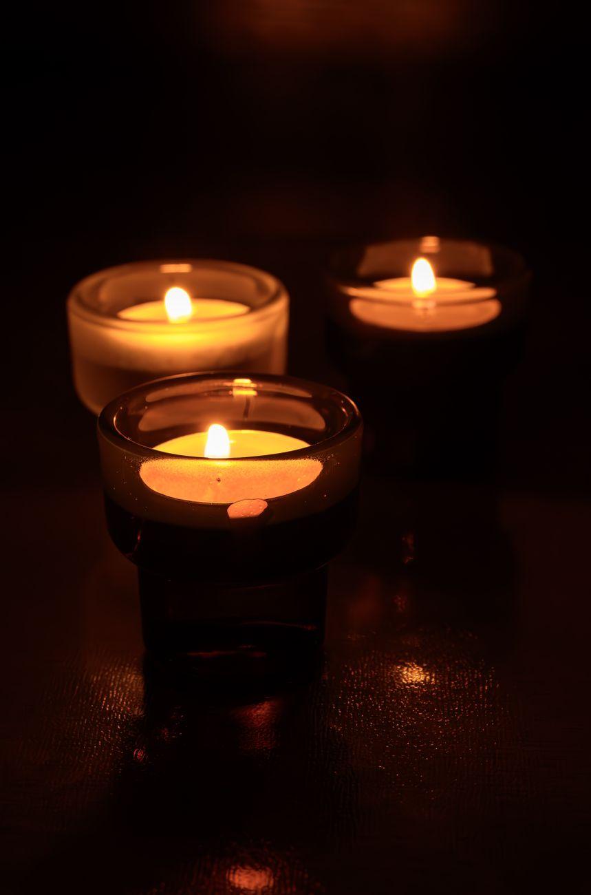 Candles glowing in a dark treatment room at Solace